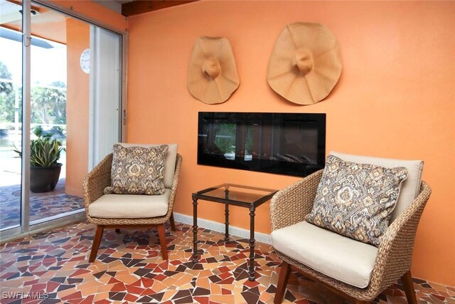 living area featuring baseboards