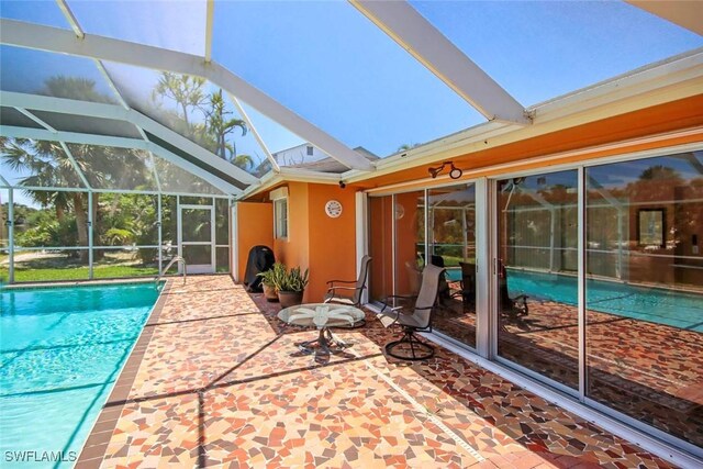 outdoor pool with a patio area and a lanai