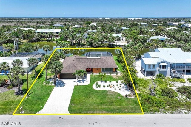 aerial view of residential area with property parcel outlined and a nearby body of water