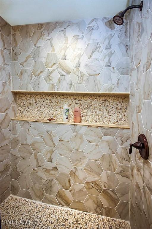bathroom with a tile shower