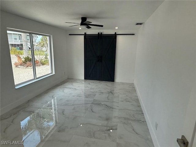 2823 Janet St, Matlacha, FL 33993 - empty room featuring a barn door, baseboards, a ceiling fan, marble finish floors, and recessed lighting
