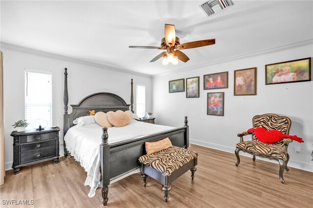 3570 43rd Ave NE, Naples, FL 34120 - bedroom with crown molding, wood finished floors, baseboards, and ceiling fan