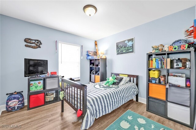 3570 43rd Ave NE, Naples, FL 34120 - bedroom featuring wood finished floors and baseboards