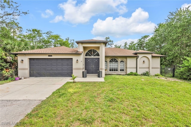 3570 43rd Ave NE, Naples, FL 34120 - view of front of home with stucco siding, a garage, and concrete driveway