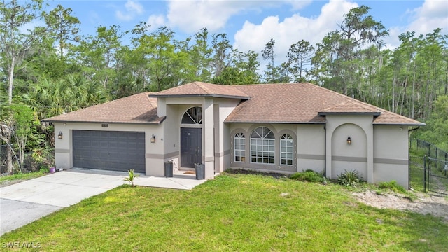 3570 43rd Ave NE, Naples, FL 34120 - view of front facade with stucco siding, an attached garage, concrete driveway, and roof with shingles