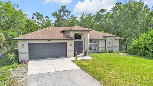 3570 43rd Ave NE, Naples, FL 34120 - view of front facade featuring driveway, an attached garage, stucco siding, and roof with shingles