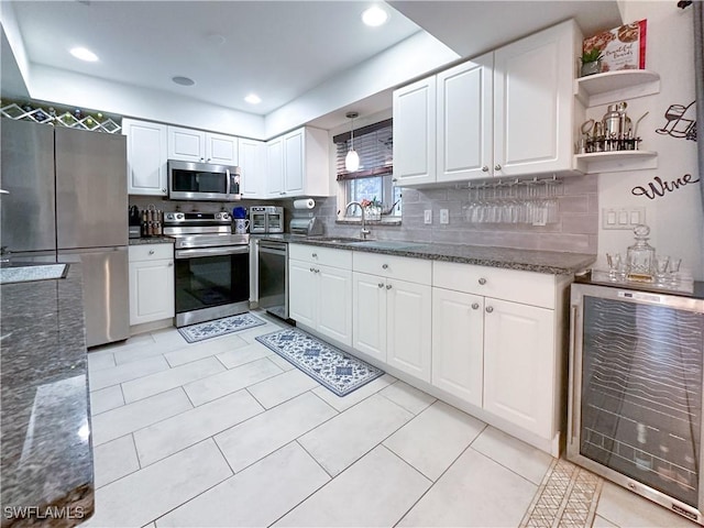 3790 35th Ave NE, Naples, FL 34120 - kitchen with stainless steel appliances, wine cooler, white cabinets, dark stone countertops, and recessed lighting