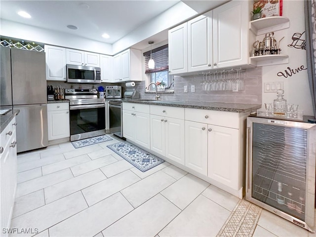 3790 35th Ave NE, Naples, FL 34120 - kitchen with stainless steel appliances, wine cooler, white cabinetry, tasteful backsplash, and open shelves