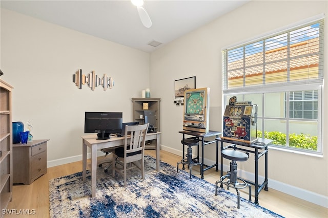 5687 Whispering Willow Way, Fort Myers, FL 33908 - home office with plenty of natural light, wood finished floors, and baseboards