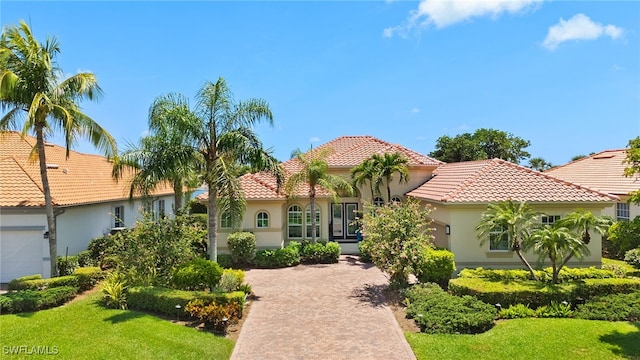 5687 Whispering Willow Way, Fort Myers, FL 33908 - mediterranean / spanish home with a tiled roof, stucco siding, and a front lawn