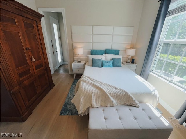 5687 Whispering Willow Way, Fort Myers, FL 33908 - bedroom featuring light wood-style floors and baseboards