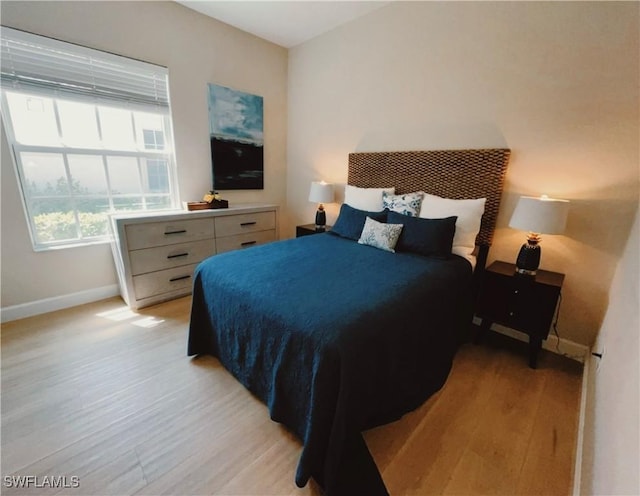 5687 Whispering Willow Way, Fort Myers, FL 33908 - bedroom featuring baseboards and light wood-style flooring