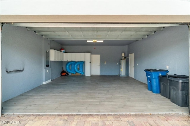 garage with water heater and electric panel