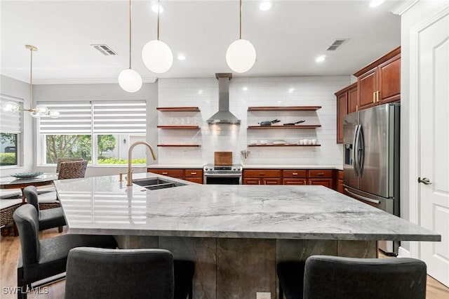kitchen with a sink, open shelves, wall chimney exhaust hood, appliances with stainless steel finishes, and crown molding