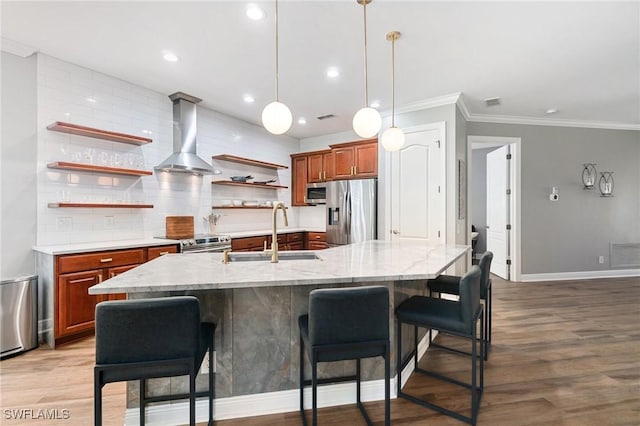 kitchen with appliances with stainless steel finishes, a sink, open shelves, brown cabinets, and baseboards