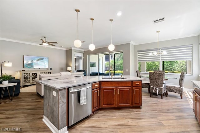 kitchen with a sink, dishwasher, open floor plan, ornamental molding, and light wood-style floors