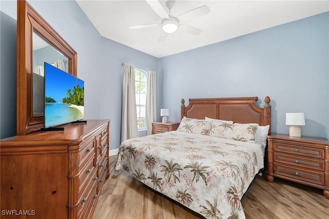 bedroom with wood finished floors, ceiling fan, and baseboards