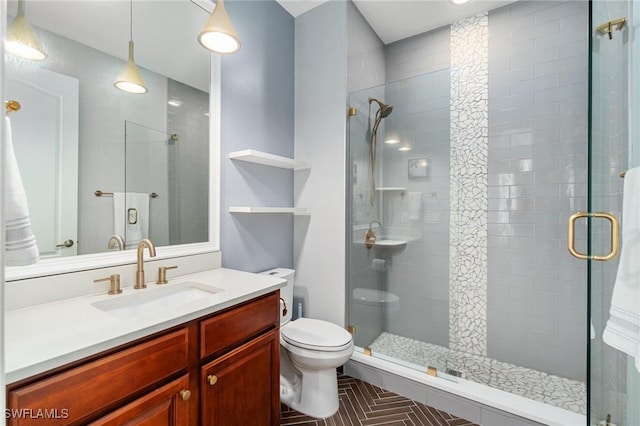 full bath featuring a stall shower, toilet, and vanity