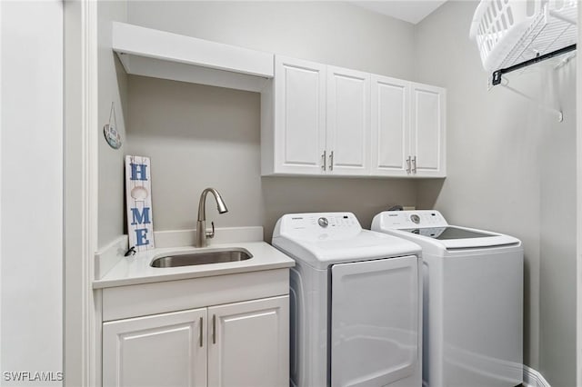 washroom with cabinet space and washing machine and clothes dryer