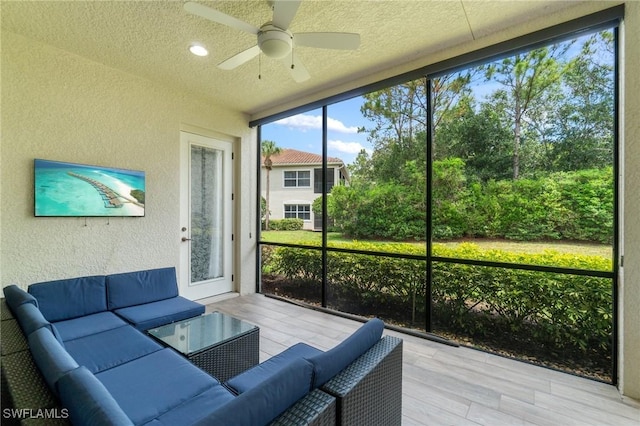 sunroom featuring an outdoor hangout area and a ceiling fan