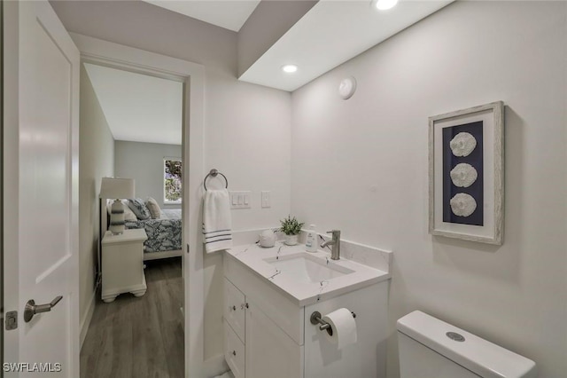 354 Harbour Dr Unit 354, Naples, FL 34103 - ensuite bathroom featuring toilet, wood finished floors, vanity, and recessed lighting