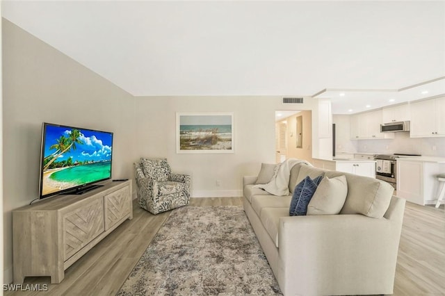 354 Harbour Dr Unit 354, Naples, FL 34103 - living room featuring light wood-style flooring, recessed lighting, and baseboards