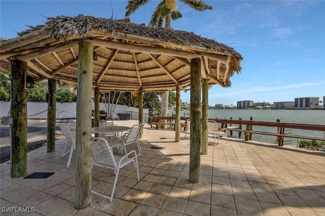 354 Harbour Dr Unit 354, Naples, FL 34103 - view of patio / terrace featuring a water view, a gazebo, fence, and outdoor dining area