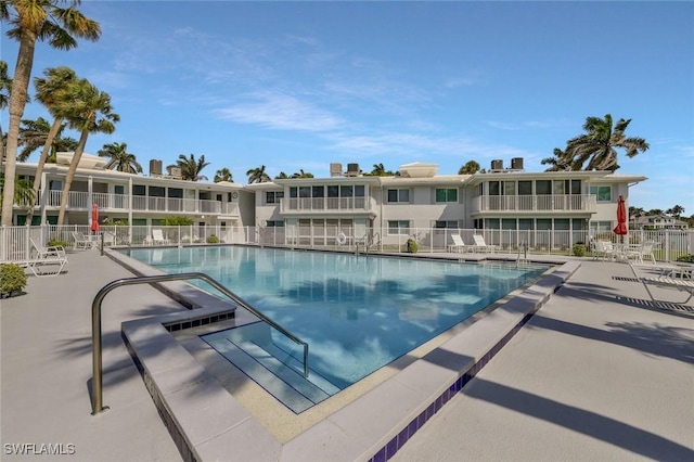 354 Harbour Dr Unit 354, Naples, FL 34103 - community pool featuring a patio and fence