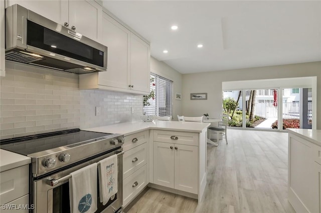 354 Harbour Dr Unit 354, Naples, FL 34103 - kitchen with appliances with stainless steel finishes, light wood-style floors, light countertops, white cabinets, and recessed lighting