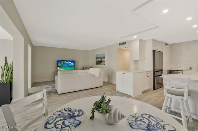 354 Harbour Dr Unit 354, Naples, FL 34103 - living room featuring light wood-style flooring, recessed lighting, and baseboards