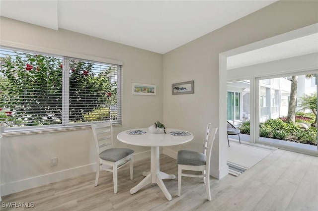 354 Harbour Dr Unit 354, Naples, FL 34103 - dining space with plenty of natural light, light wood-style floors, and baseboards