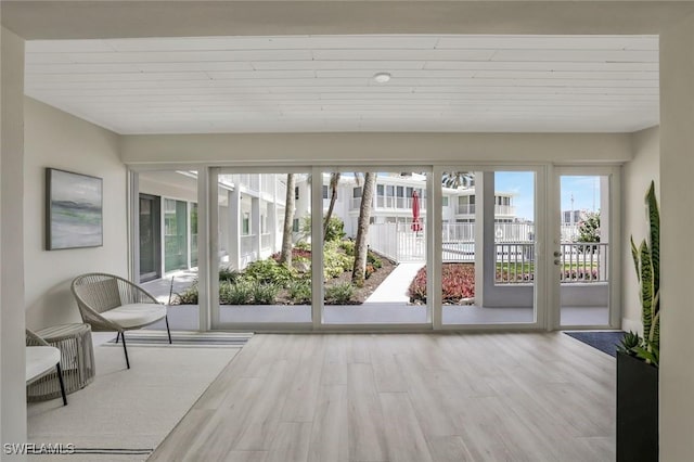 354 Harbour Dr Unit 354, Naples, FL 34103 - unfurnished sunroom featuring wood finished floors