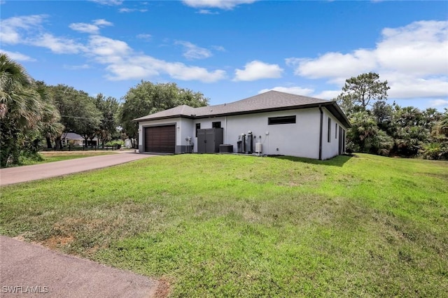79 41st Ave NE, Naples, FL 34120 - view of front of home featuring a garage, concrete driveway, a front yard, central air condition unit, and stucco siding