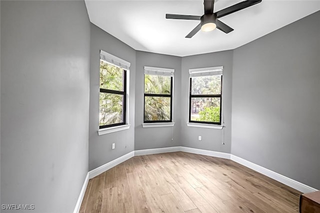 79 41st Ave NE, Naples, FL 34120 - spare room featuring plenty of natural light, baseboards, and wood finished floors