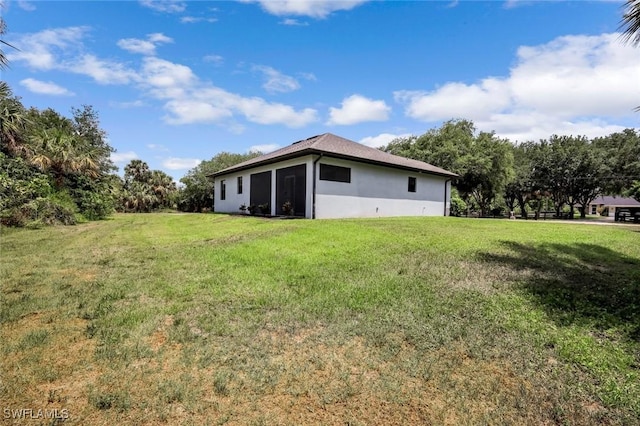 79 41st Ave NE, Naples, FL 34120 - back of property with a yard and stucco siding