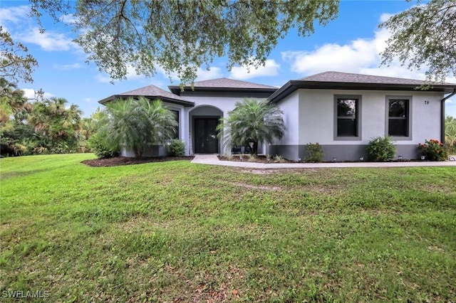 79 41st Ave NE, Naples, FL 34120 - ranch-style home featuring stucco siding and a front yard