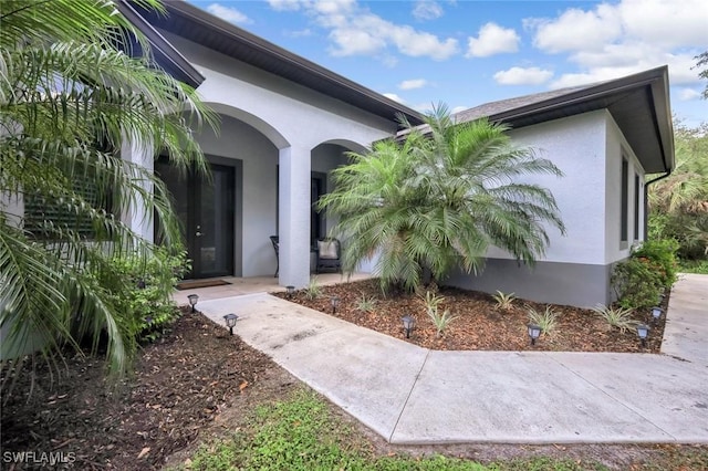 79 41st Ave NE, Naples, FL 34120 - doorway to property featuring stucco siding