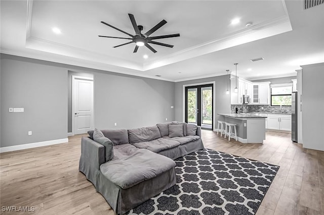 79 41st Ave NE, Naples, FL 34120 - living area featuring a raised ceiling, plenty of natural light, ceiling fan, ornamental molding, and recessed lighting