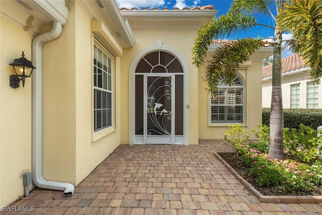 property entrance with stucco siding