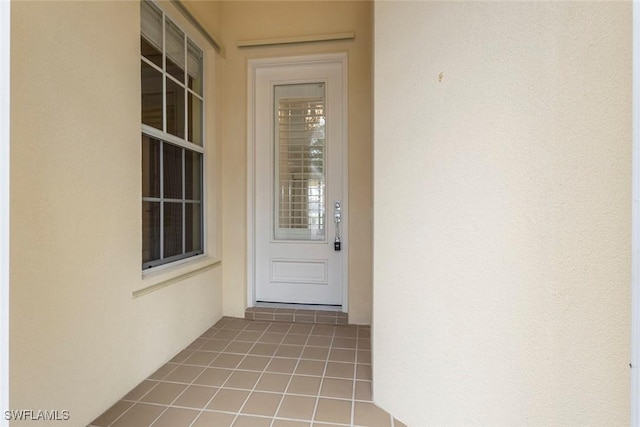 entrance to property with stucco siding