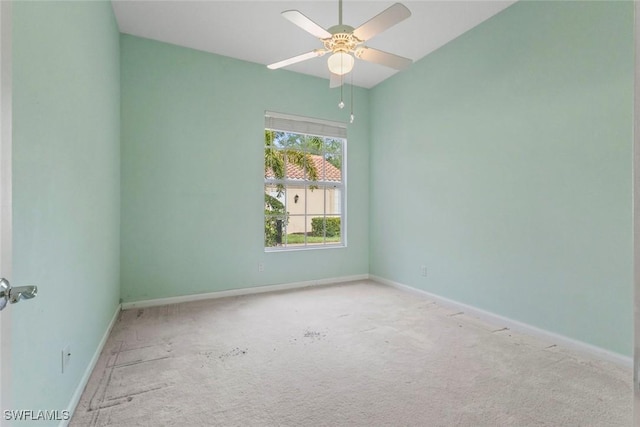 empty room featuring baseboards, carpet flooring, a ceiling fan, and vaulted ceiling