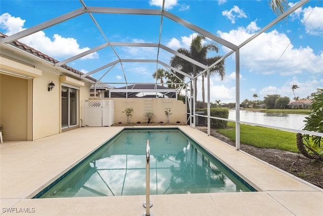 outdoor pool with a water view, a patio area, and a lanai