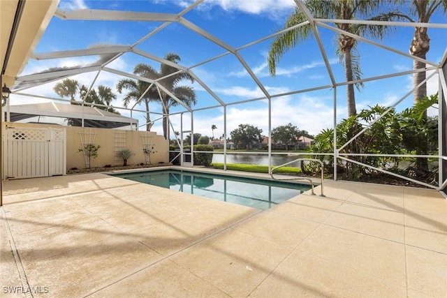 swimming pool with a patio area, a water view, and glass enclosure