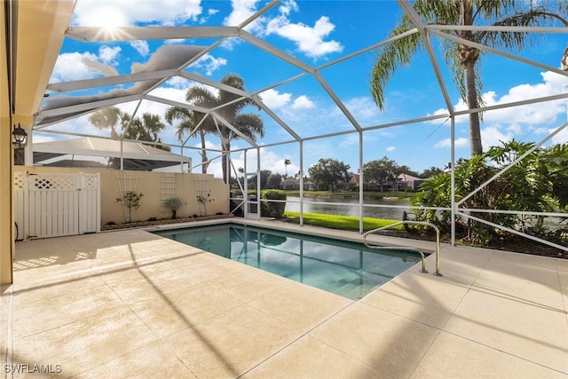 swimming pool with a water view, a patio area, and glass enclosure