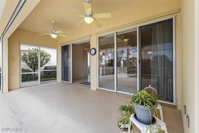 unfurnished sunroom featuring a ceiling fan