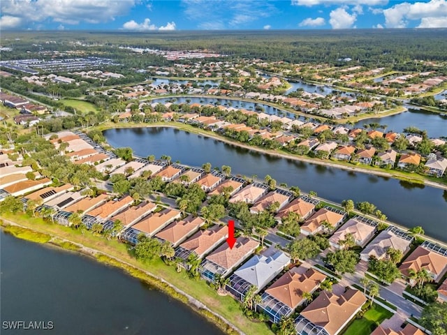 aerial view of property's location featuring nearby suburban area and a nearby body of water