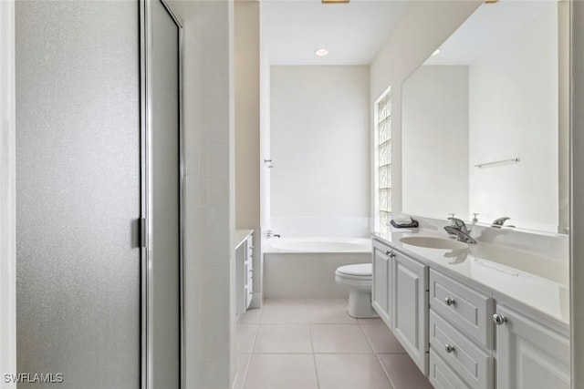 full bathroom featuring tile patterned floors, vanity, a bath, a stall shower, and toilet