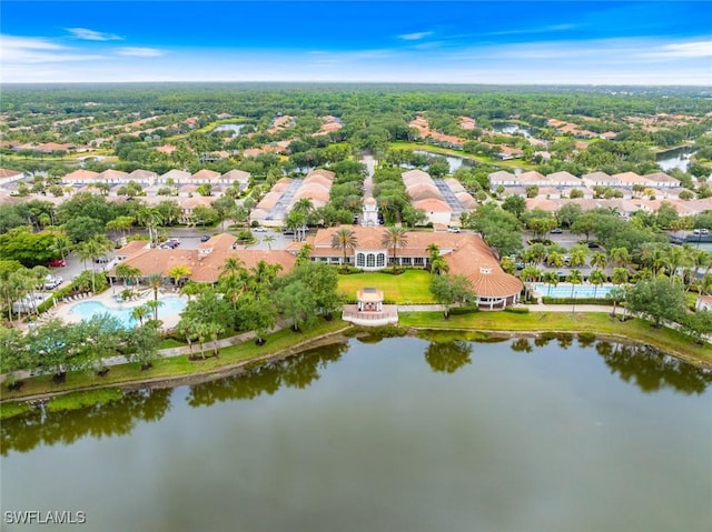aerial overview of property's location with a nearby body of water, a pool, and nearby suburban area