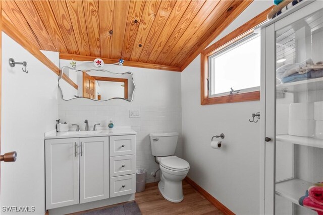 150 Pearl St, Fort Myers Beach, FL 33931 - half bath featuring wooden ceiling, toilet, wood finished floors, tile walls, and vanity