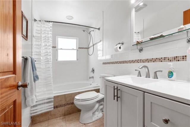150 Pearl St, Fort Myers Beach, FL 33931 - full bathroom featuring tiled shower / bath combo, tile patterned floors, tile walls, toilet, and vanity